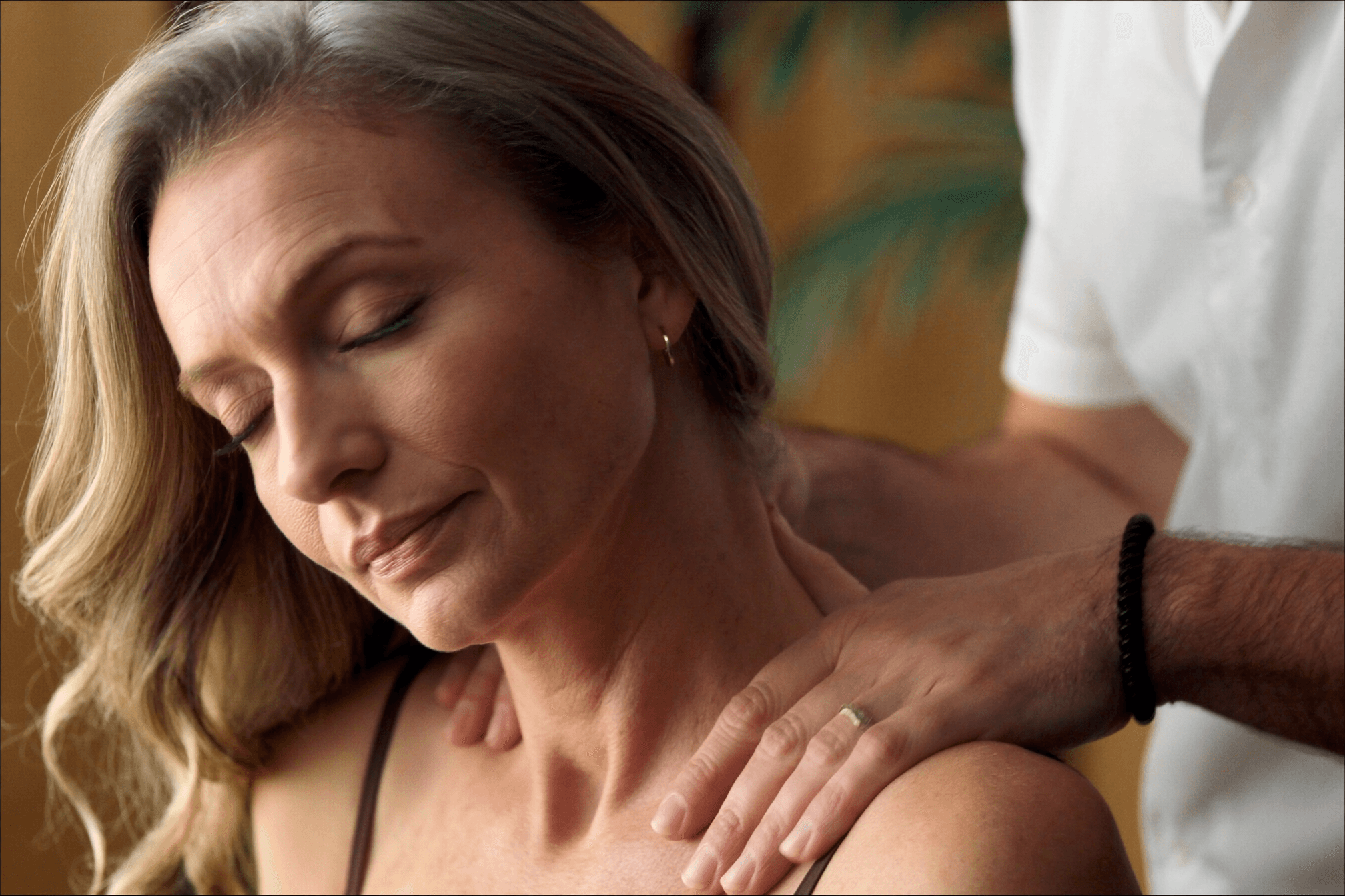Woman booking a regular massage appointment at a calm independent wellness clinic