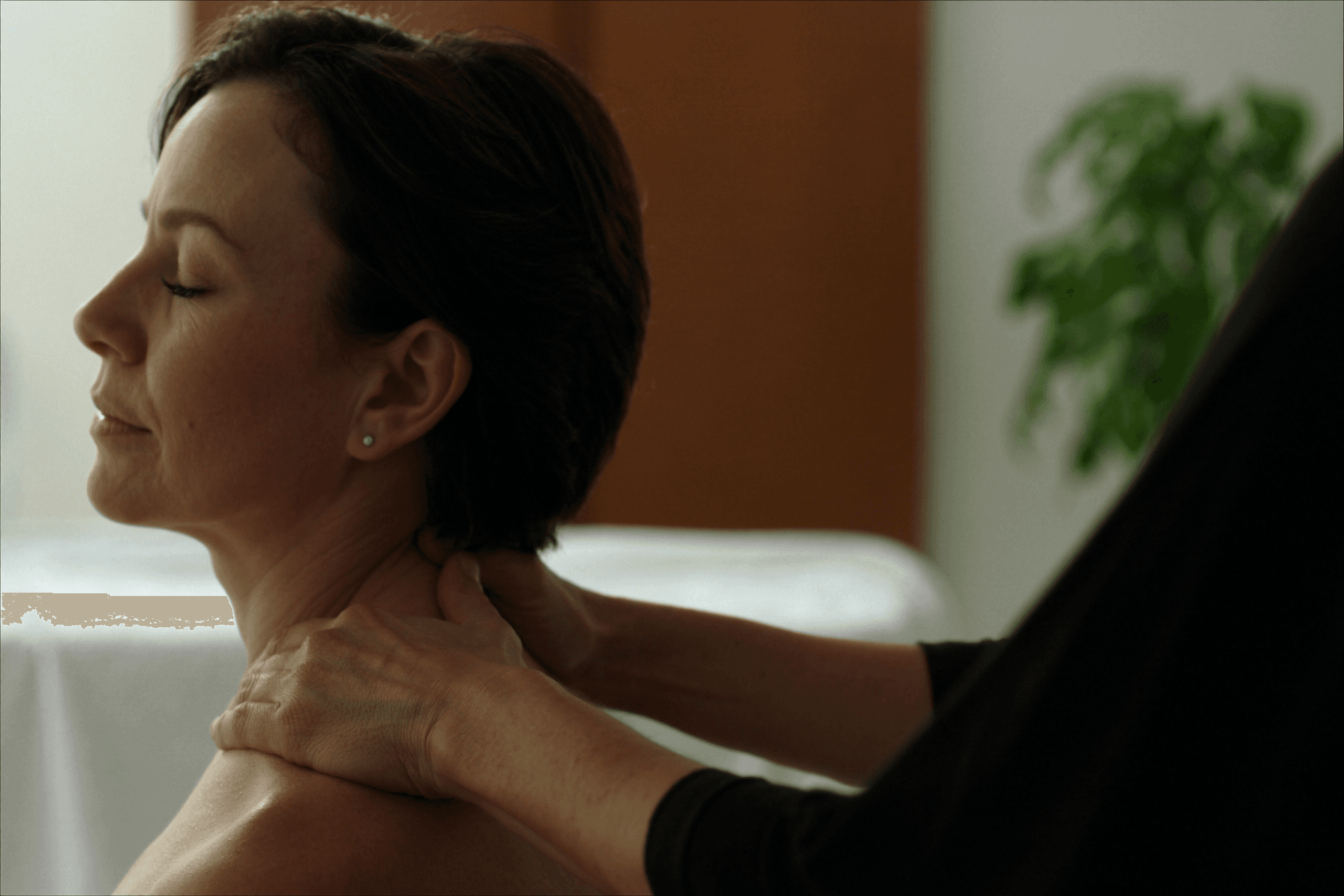 Woman receiving a relaxing head and shoulder massage in a calm treatment room